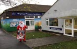 Santa carrying gifts for pupils at Warren Primary Academy